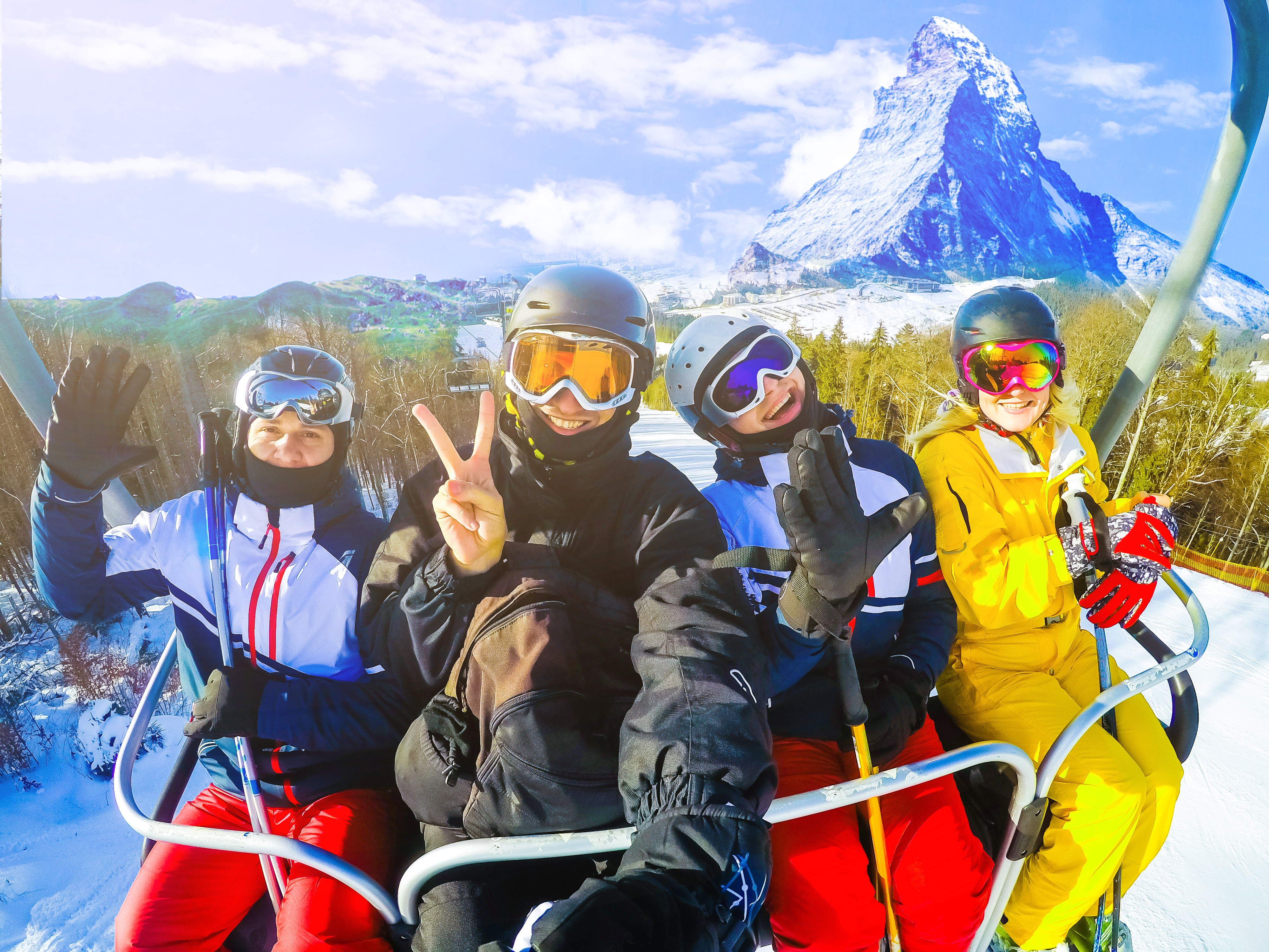 four snowboarders on ski lift